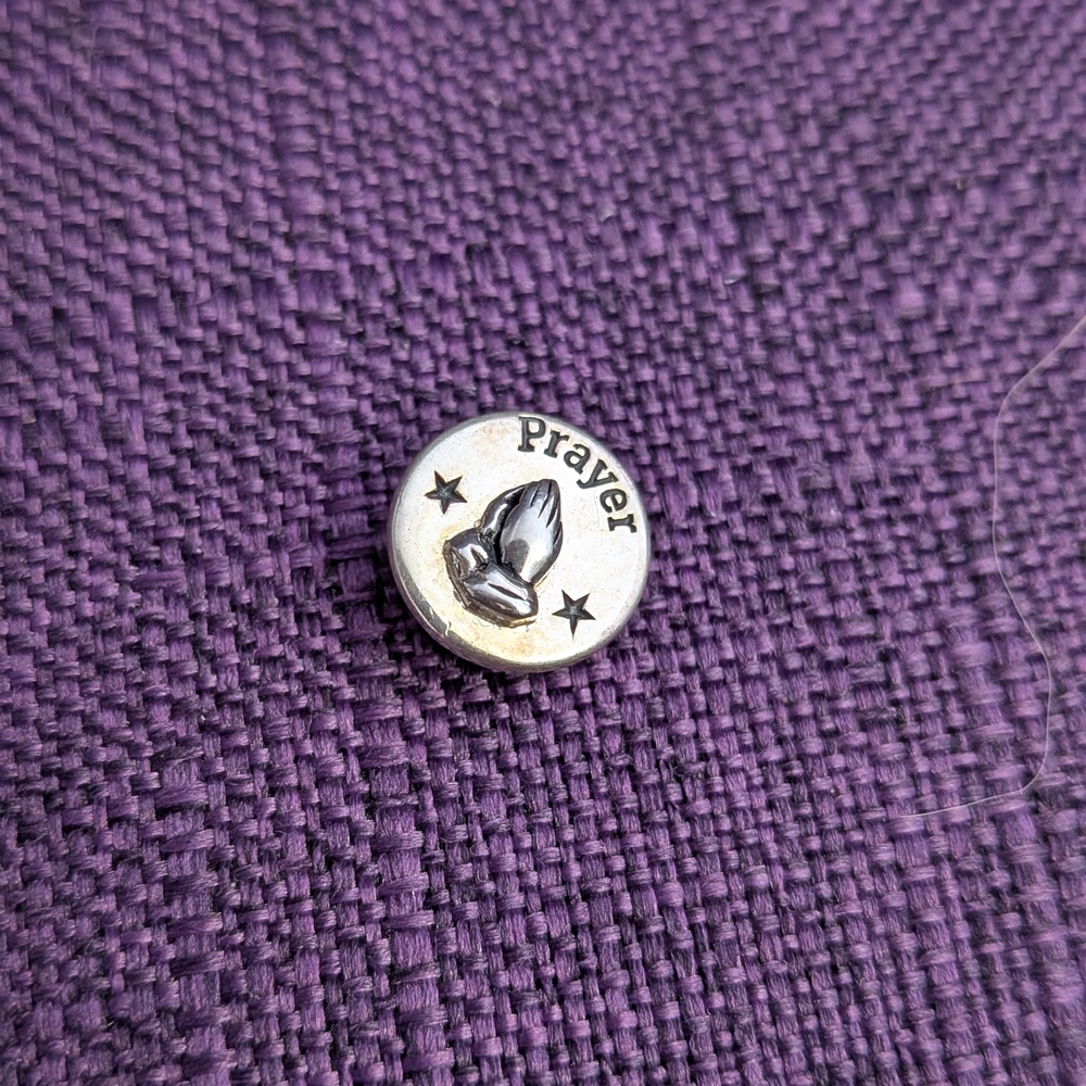 Silver Prayer Pin on Purple Fabric